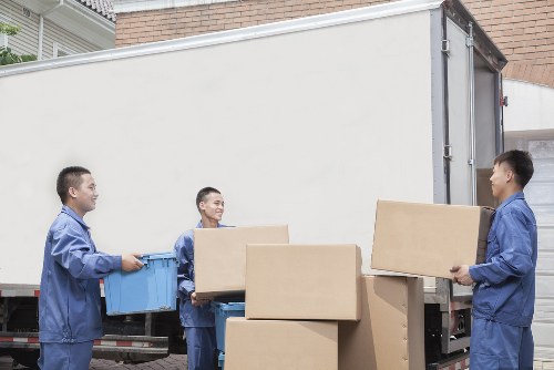 Man and van removal team loading furniture in Pimlico street
