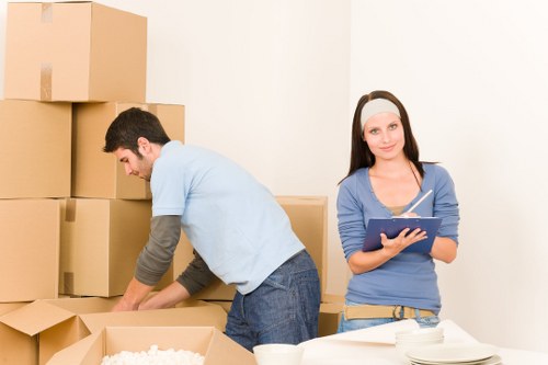 Professional movers loading furniture into a van in central London